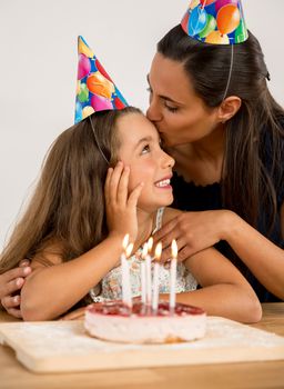 Shot of a mother and daughter in the kitchen celebrating Daughter's birthday