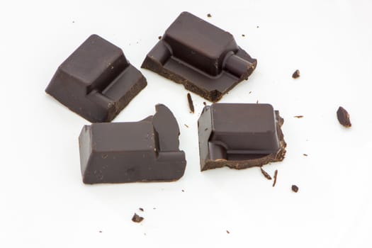four diceds of the black chocolate on the white background