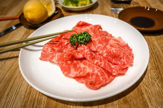 Raw Kobe wagyu beef slices in a plate