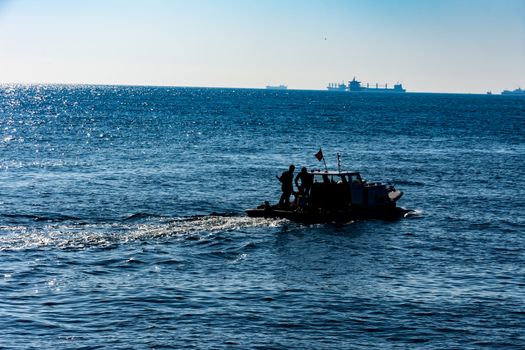 people are fishing from the boat on the sea