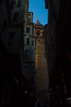 People walking to the narrow street to the Galata tower