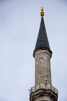 Minaret of the famous Fatih mosque built in ottoman empire in city of Istanbul