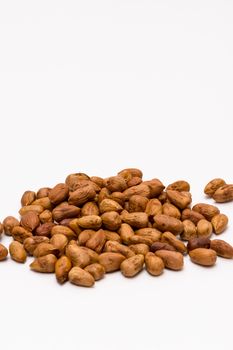 pile of pealed hazelnuts on the white background