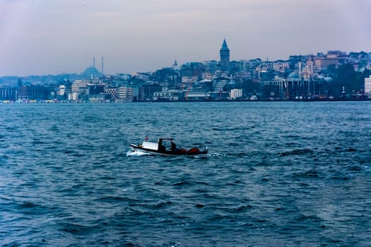 taking picture of the Galata Tower from the sea while driving on the boat