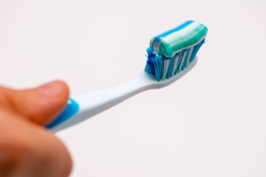 girl holding toothbrush covered by paste