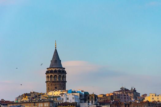 Famous Galata Tower surrounded by other buildings in the Karakoy, Istanbul