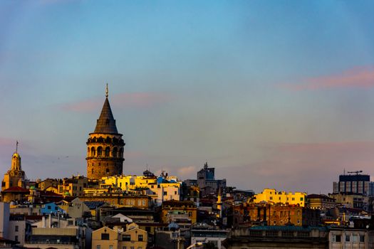 Famous Galata Tower surrounded by other buildings in the Karakoy, Istanbul