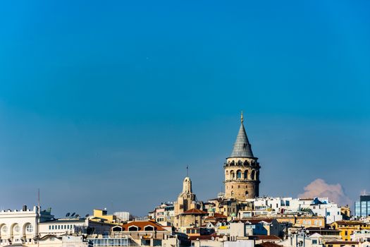 Famous Galata Tower surrounded by other buildings in the Karakoy, Istanbul