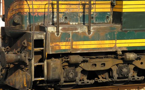 Close up view on old rusty green locomotive
