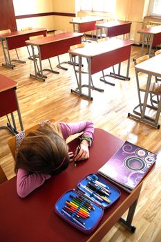 Lonely and bored student in the empty classroom