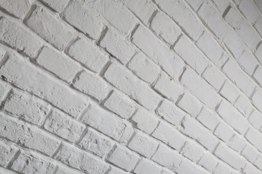 Old white painted brick wall background texture. Diagonal alignment.