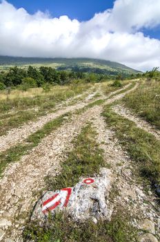 Hiking path and sign near mountain peak