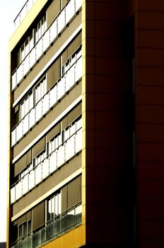 Details of a modern yellow building on sunny day