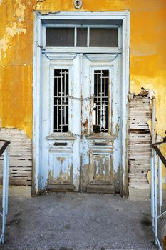 Old rustic yellow house with white door