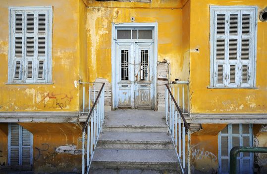 Old rustic yellow house with white door