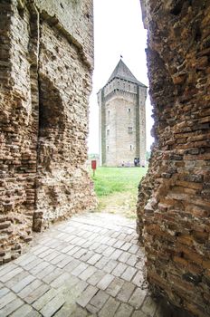 Old damaged brick castle on cloudy day