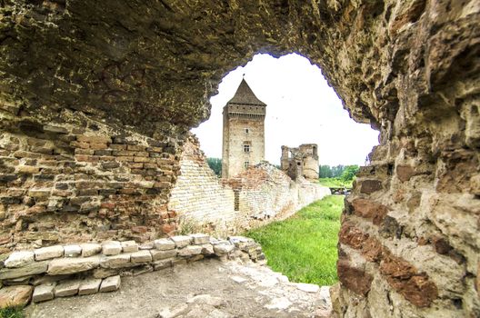 Old damaged brick castle on cloudy day