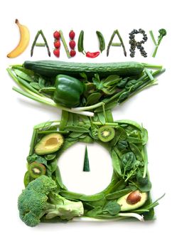 January on kitchen weighing scales made of fruits and vegetables 