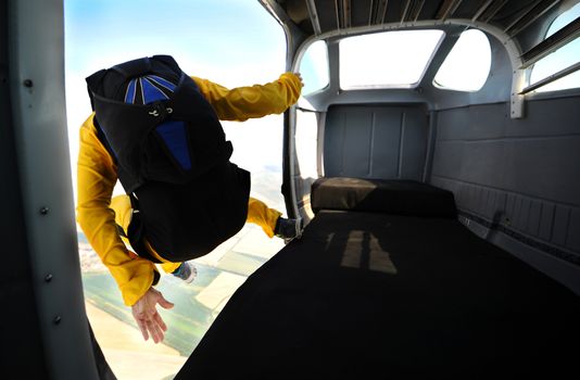 Parachutist jumping from the plane on sunny day