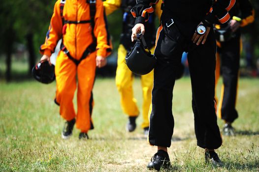 Parachutists fully equipped on the way to airplane