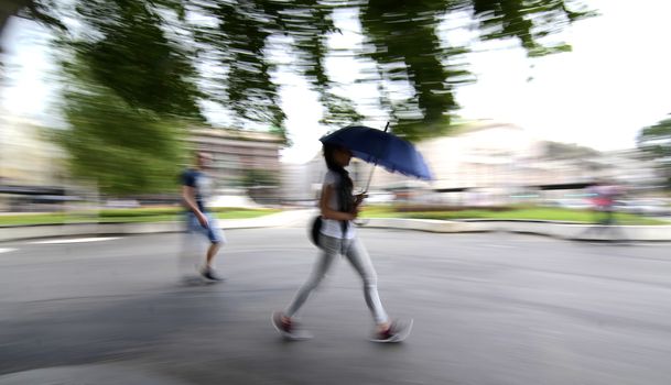 People with umbrella walking around the city during bad weather
