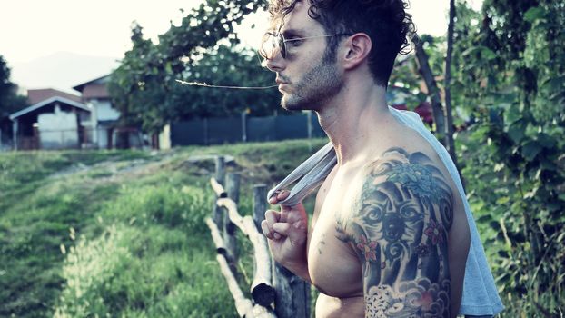 Handsome Muscular Shirtless Hunk Man Outdoor in Country Standing on Grass. Showing Healthy Muscle Body While Looking away