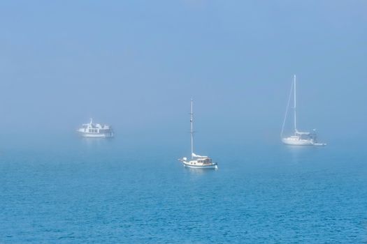 Sailing boats moored on a misty harbor in Boston, Linconlnshire. United Kingdom.