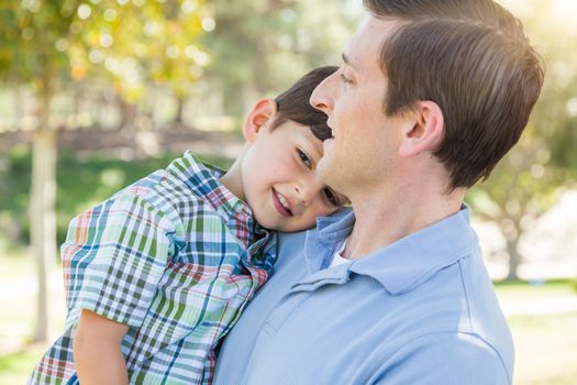 Happy Caucasian Father and Son Playing Together in the Park.