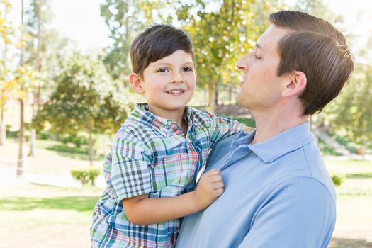 Happy Caucasian Father and Son Playing Together in the Park.