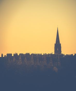 Retro Style Image Of A Row Of Edinburgh Tenement Apartments And Church Spire At Sunset