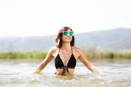 sexy girl splashing water in the air