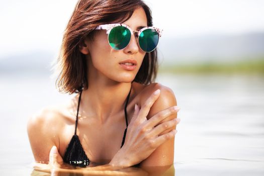 portrait of a sexy girl hugging herself in water