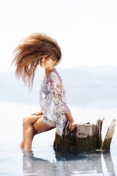 beautiful girl in a lake with hair in the air
