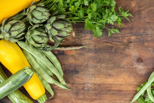 Fresh organic green vegetables wooden floor with copy space. Green and yellow vegetables background. Healthy eating background. Vegetarian food, organic food.