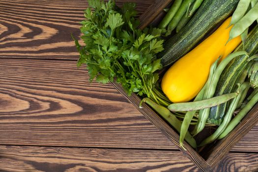 Fresh organic green vegetables wooden floor with copy space. Green and yellow vegetables background. Healthy eating background. Vegetarian food, organic food.