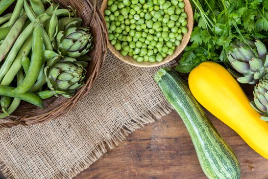 Fresh organic green vegetables wooden floor with copy space. Green and yellow vegetables background. Healthy eating background. Vegetarian food, organic food.