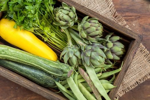 Fresh organic green vegetables wooden floor with copy space. Green and yellow vegetables background. Healthy eating background. Vegetarian food, organic food.