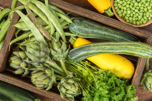 Fresh organic green vegetables wooden floor with copy space. Green and yellow vegetables background. Healthy eating background. Vegetarian food, organic food.