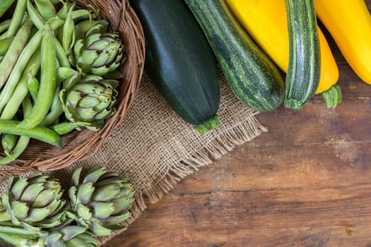 Fresh organic green vegetables wooden floor with copy space. Green and yellow vegetables background. Healthy eating background. Vegetarian food, organic food.