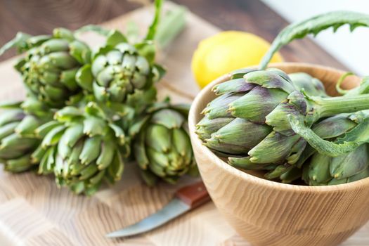 Two artichoke bouquets on kitchen table among some kitchen items