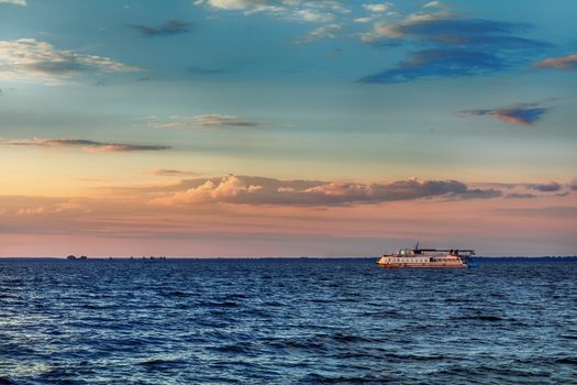  Amazing colors of the sky before sunset over the river in the summer time. Tourist boat is on the beautiful blue water. Dnieper river