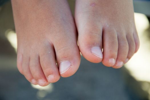 Baby feet over the sand black and white