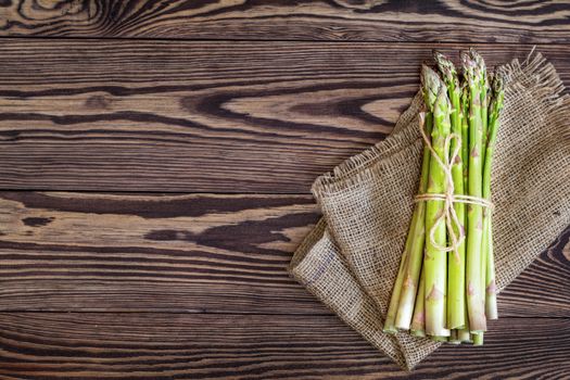 Bunch of fresh green asparagus spears on a rustic wooden table