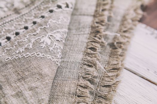 Embroidery background. Linen with needlework in progress. Coloring and processing photos. Shallow depth of field.