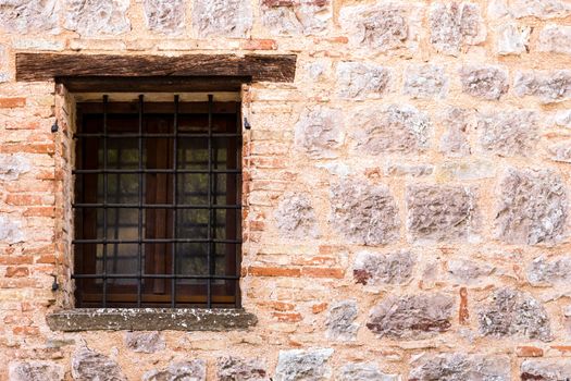 Assisi (Italy): Window on medieval stone wall