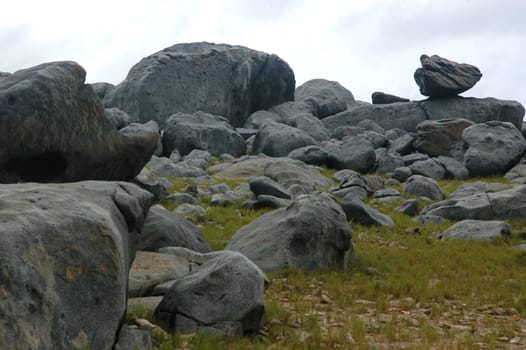 Huge pile of big rocks against sky