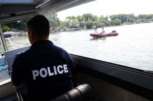 River police in summer day patrol action