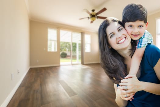 Young Mother and Son Inside Empty Room with Wood Floors.