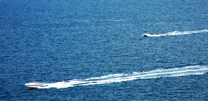 Far distance view on two speedboats on summer day