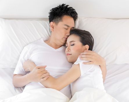 Young loving couple in the bed. Modern lifestyle concept